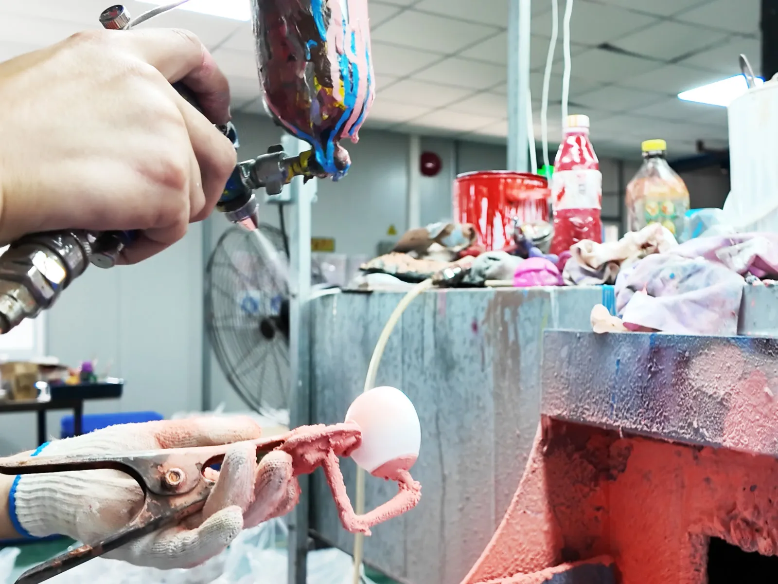 Manual spraying process is underway in the toy factory for toys