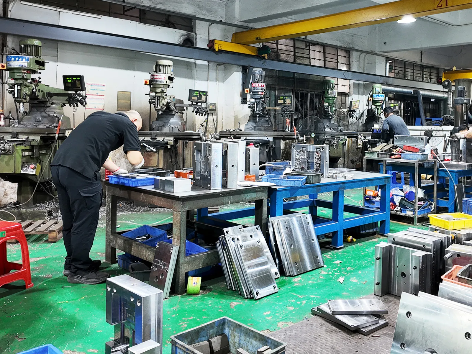 Engineers are inspecting the mold condition before PVC toy injection molding operations