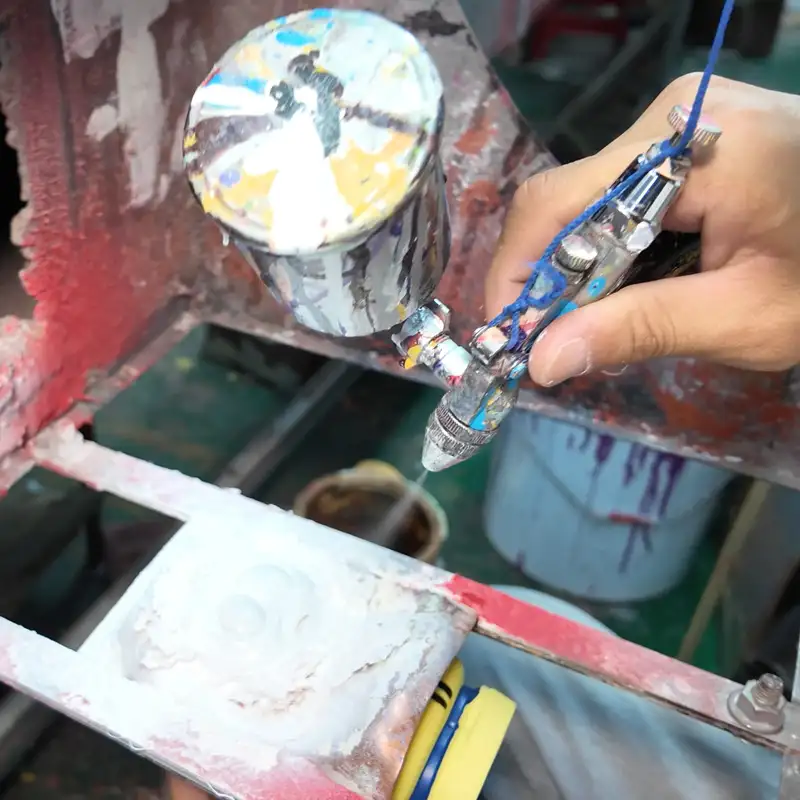 Toy spray painting and coloring are in progress.